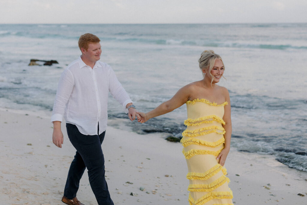 Erin and Tyler walking on the beach at their destination wedding at UNICO 20°87° Hotel Riviera Maya